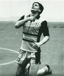 Stan Terlecki on his knees looking skyward after a goal, black and white